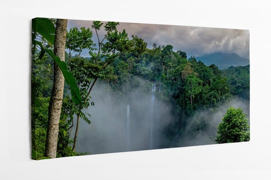 Obraz na płótnie HOMEPRINT, Antena nad wodospadem Sekumpul otoczonym gęstym lasem deszczowym i górami spowitymi mgłą 100x50 cm HOMEPRINT