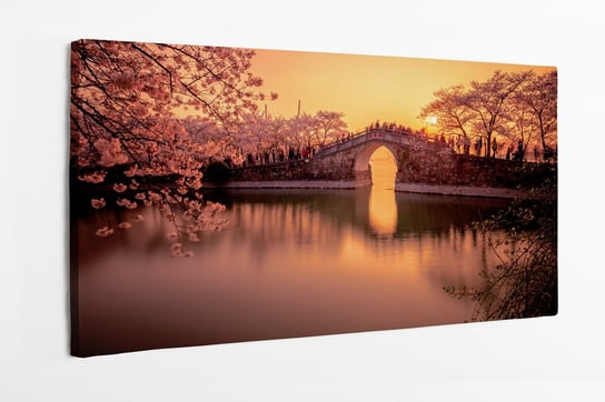 Obraz na płótnie HOMEPRINT, kwiat wiśni o zachodzie słońca na tle mostu, Japonia 100x50 cm HOMEPRINT