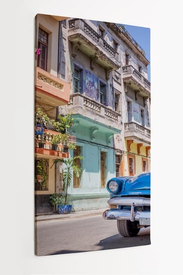 Obraz na płótnie HOMEPRINT, niebieski zabytkowy klasyczny amerykański samochód, kolorowa uliczka, Hawana, Kuba 50x100 cm HOMEPRINT